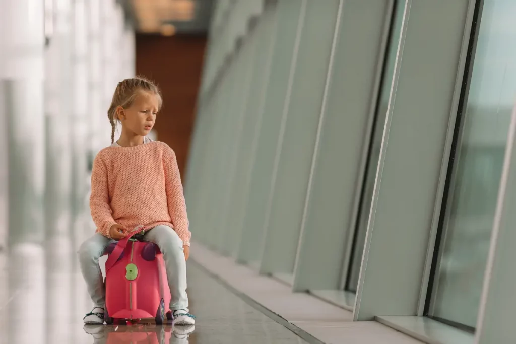 Kind-am-Flughafen-mit-Koffer zum draufsitzen